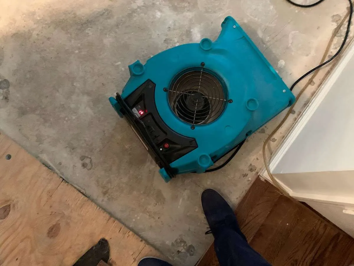 Air mover drying subfloor during Commercial Water Damage Restoration in Buckhead